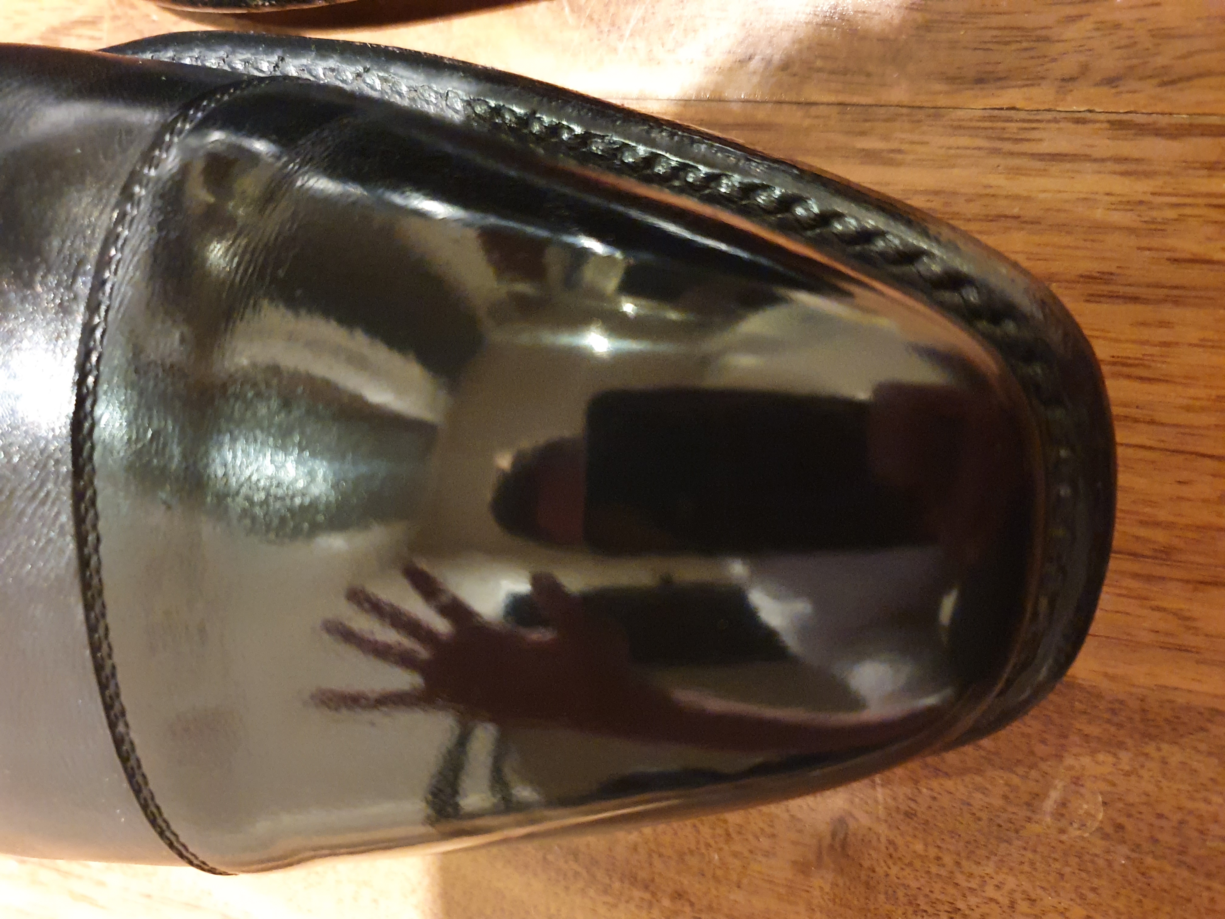 Shoeshine mirror effect on toe cap of black pair of Wildsmith boots